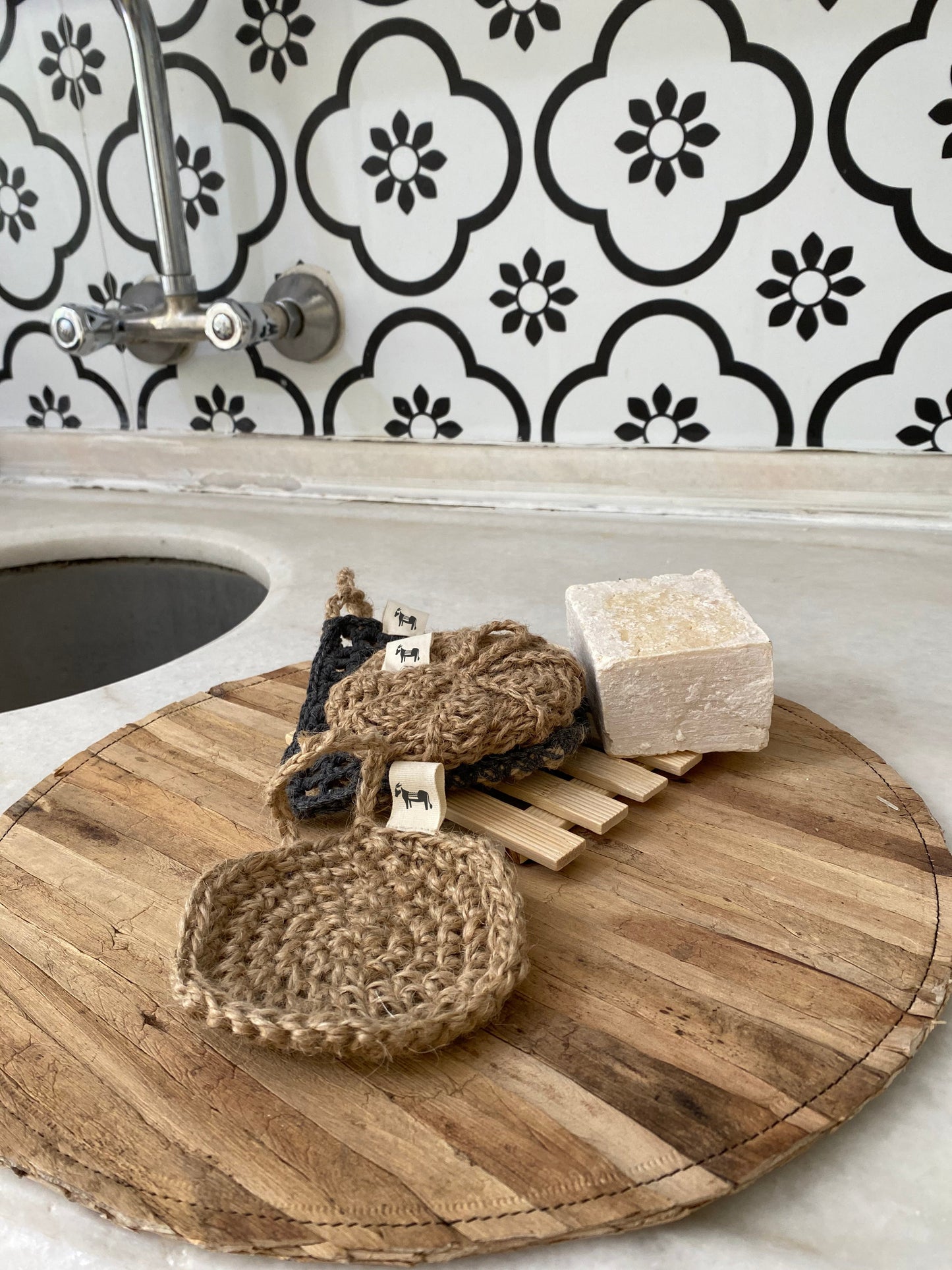 Natural fibers of the jute scrubber 'Flat Earth', styled on a woven basket background.
