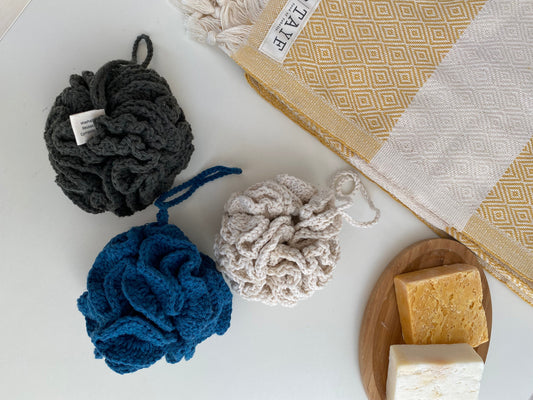 The Lefe Shower Flower — 100% Cotton Zero-Waste Sponge in creme, soft focus, styled on a shower floor