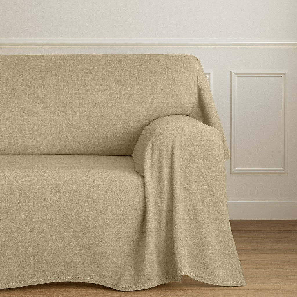 The Armor waterproof sofa cover in beige fabric, fitted on a living room sofa