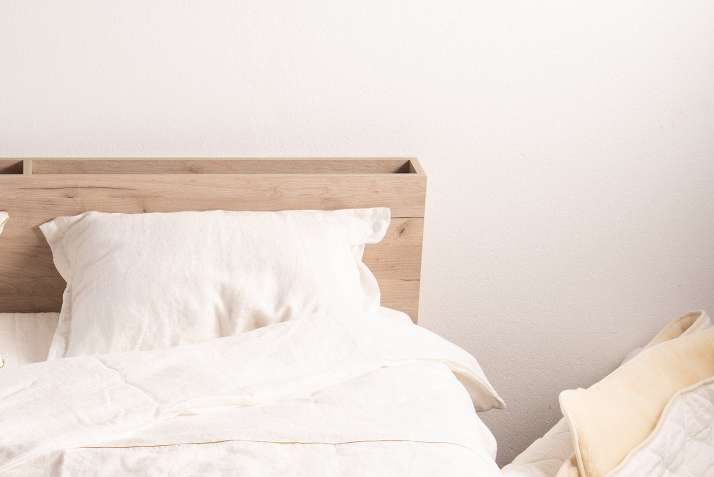 Adjusting the height of the pillow by pulling out the woolen stuffing