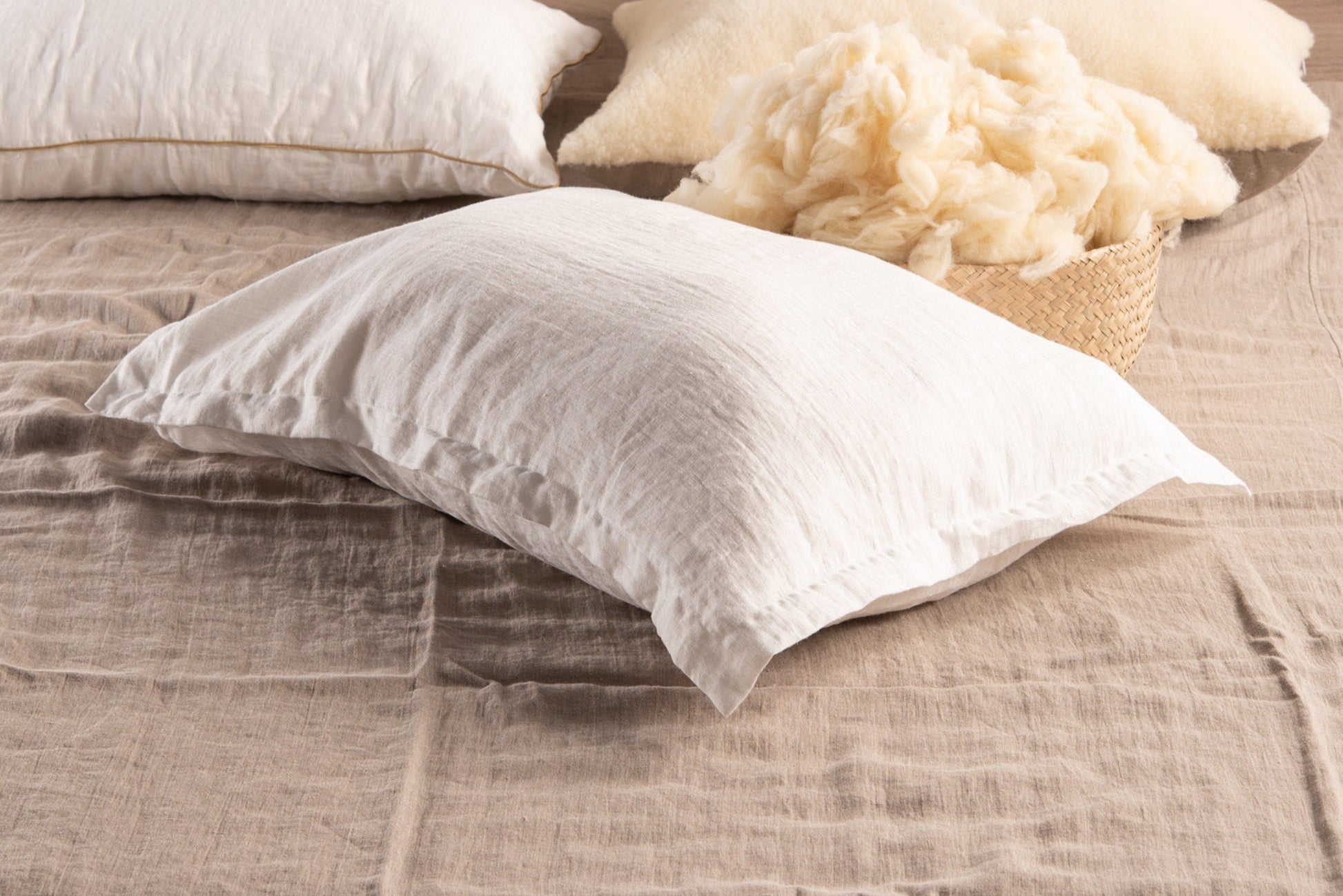 Organic Pillow with Raw Merino Wool Filling in white linen case on a bed