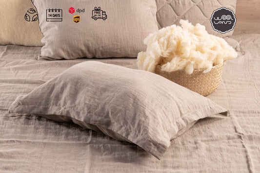 Organic Pillow with Raw Merino Wool Filling on a bed in natural linen case