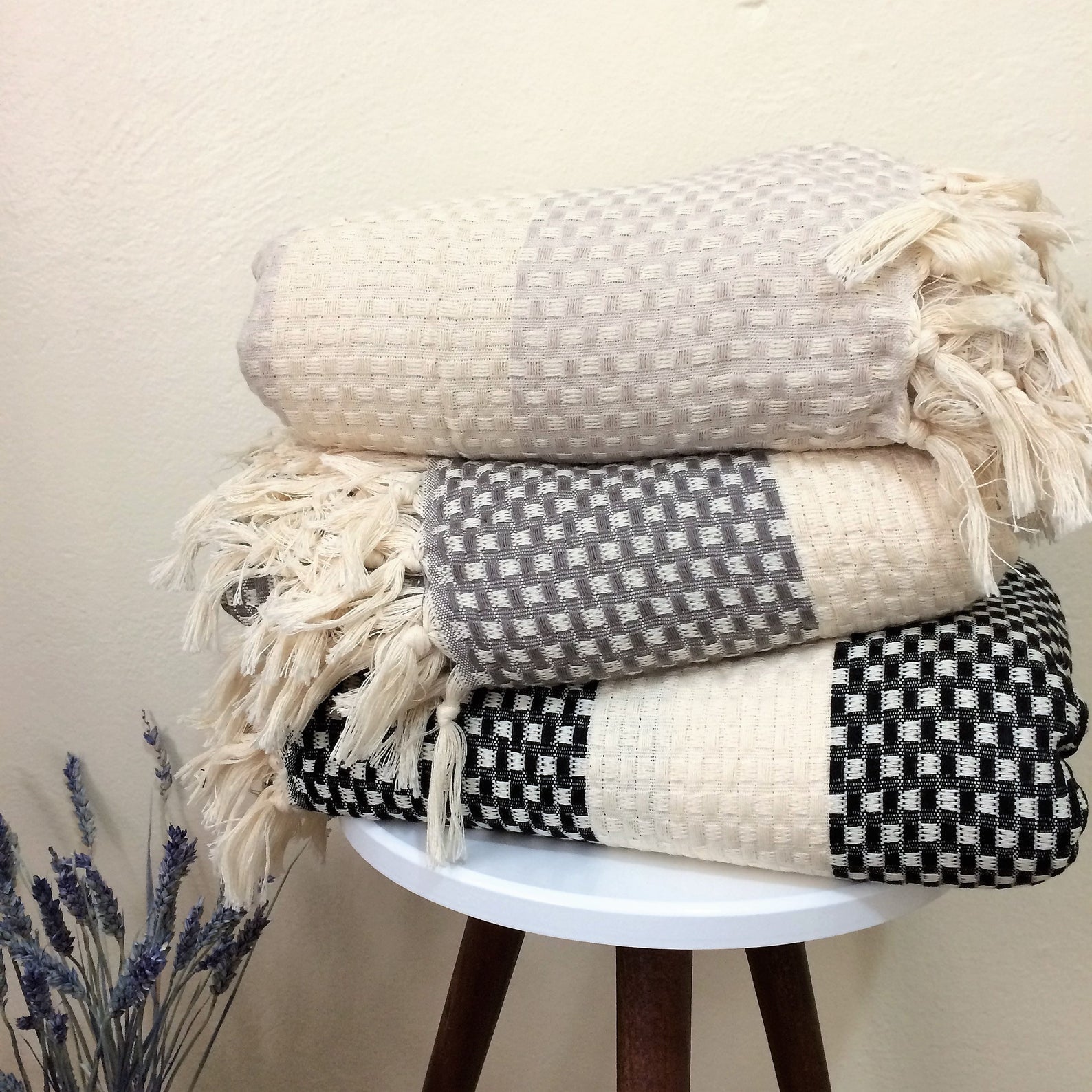 The Istanbul Handwoven Cotton blanket on the couch, in a relaxed lifestyle setting